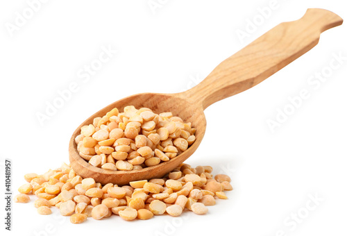 Split yellow peas in a wooden spoon on a white background. Isolated