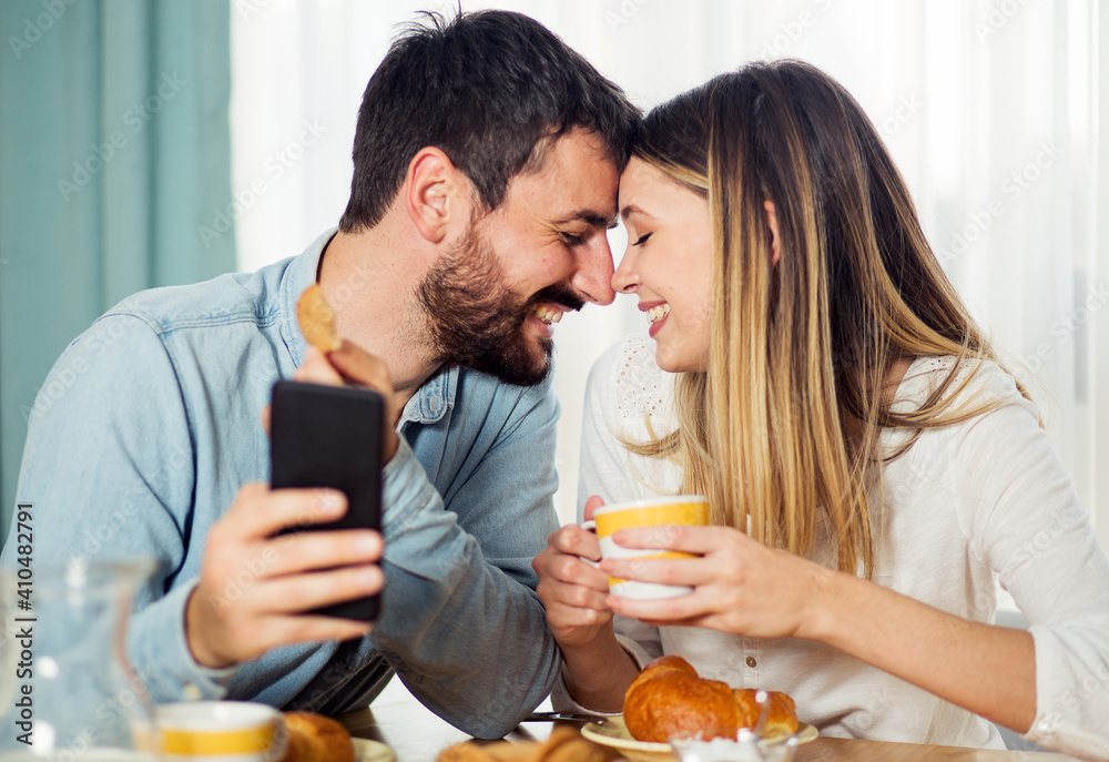 Couple have breakfast and using phone Couple have breakfast and using phone