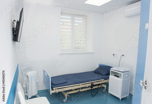 Modern empty and clean hospital room with medical equipment and TV © smirart
