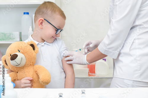 Little boy receiving vaccination at the clinic, close up.