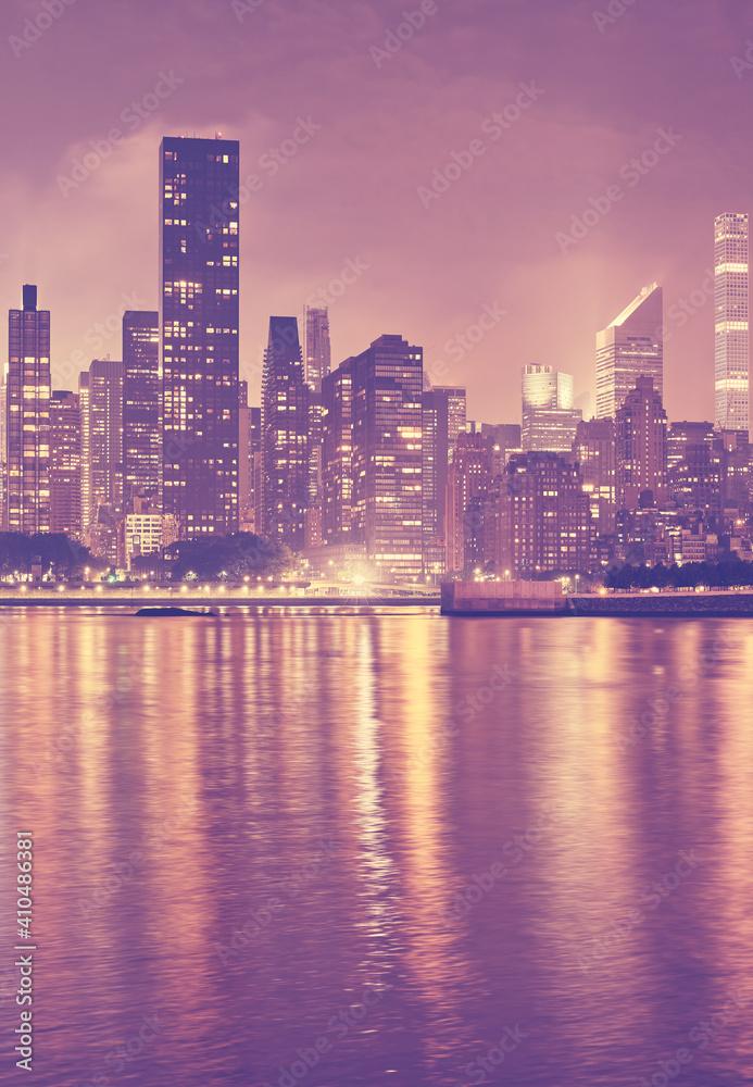 Fototapeta premium Manhattan skyline at night, color toning applied, New York City, USA.