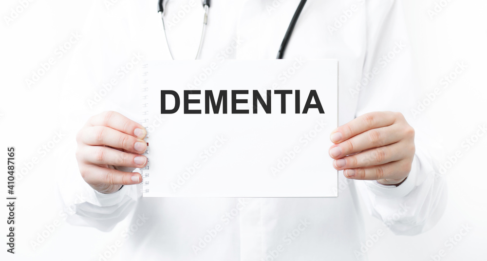 Doctor holding a card with text DEMENTIAL, medical concept Doctor holding a card with text DEMENTIAL, medical concept