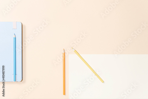 Diary and colored pencils separated on cardboard backgrounds photo