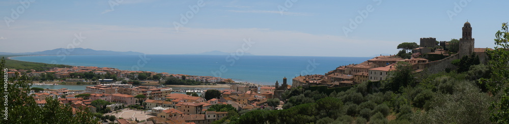 Panorama of the fortified medieval village of Castiglione della Pescaia and of its coast lapped by the Tyrrhenian Sea.