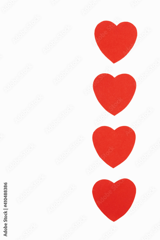 Red hearts in a row on a white background. Valentine's day symbol, holiday concept, minimal style.