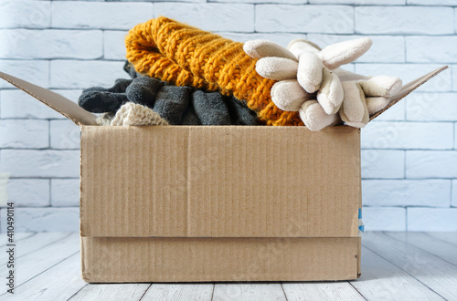 donations to the needy, warm clothes in a cardboard box
