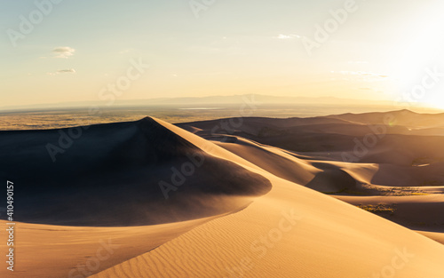 Panorama of windy sandy dunes at golden sunset in great sand dunes national park in america