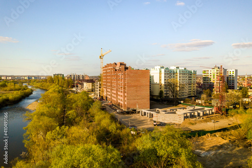 Aerial view of tall residential apartment buildings under construction and Bystrytsia river in Ivano-Frankivsk city, Ukraine. photo