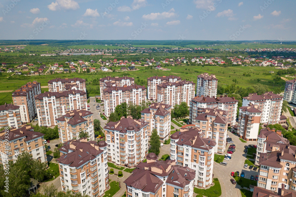 Top view of apartment or office tall buildings, parked cars, urban city landscape. Drone aerial photography.