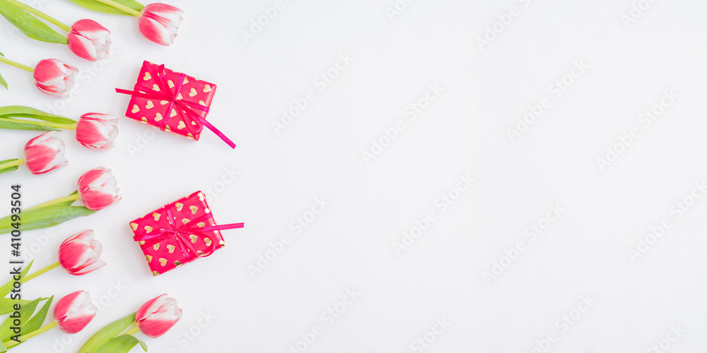 Flat lay valentines day frame with pink tulips and gift box on a white background Flat lay valentines day frame with pink tulips and gift box on a white background