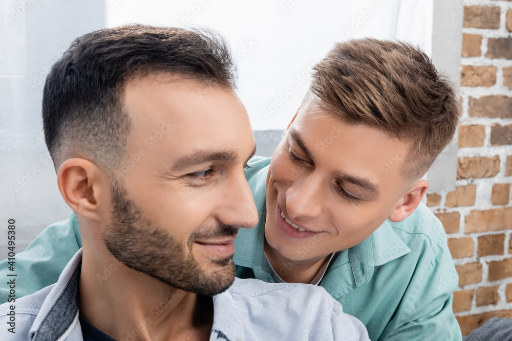 happy same sex family smiling and looking at each other happy same sex family smiling and looking at each other