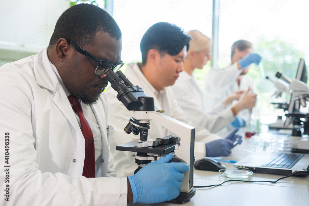 Scientist working in lab. Doctors making medical research. Biotechnology, chemistry, science, experiments and healthcare concept. Day light and window background. Scientist working in lab. Doctors making medical research. Biotechnology, chemistry, science, experiments and healthcare concept. Day light and window background.