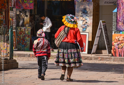 Traditional Quechua woman and her kid in the Sacred Valley, Peru