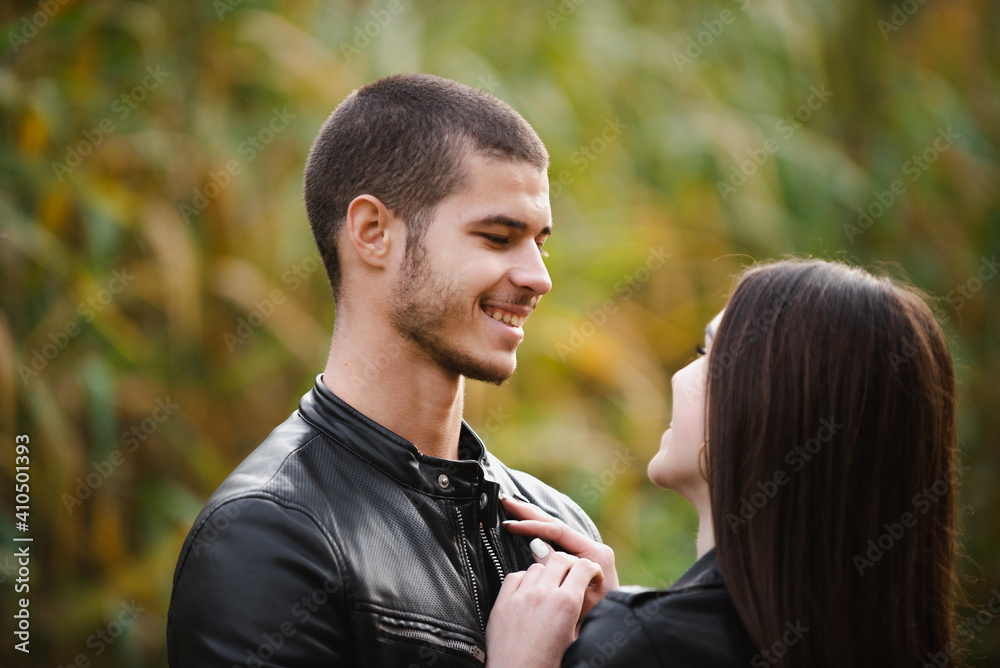Fototapeta premium The guy with the girl lovers walk in the park autumn