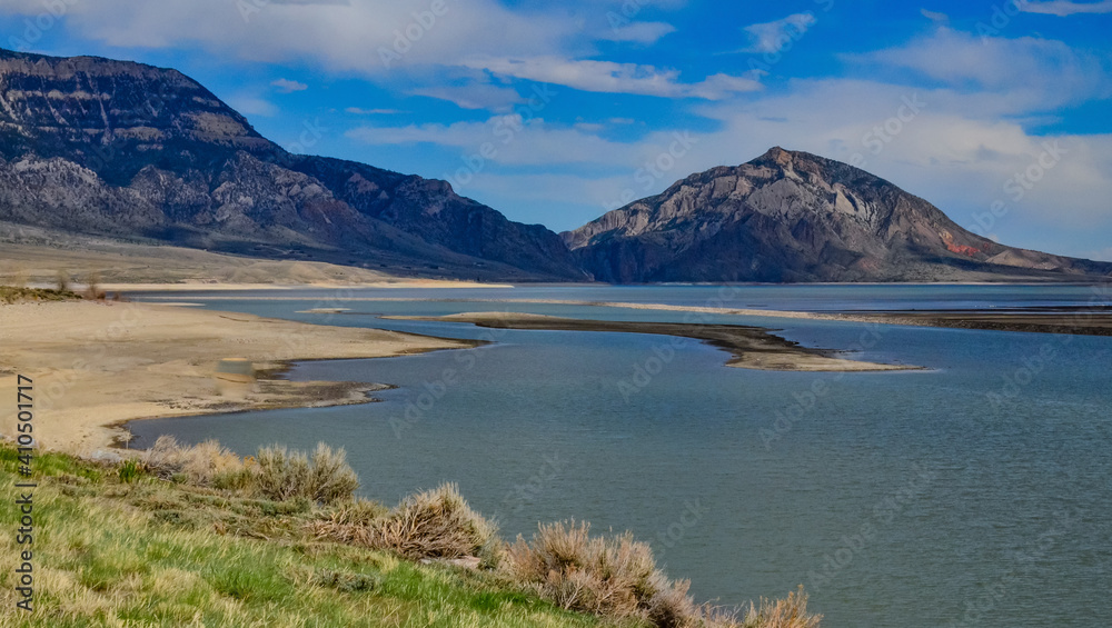 Mountain landscape, small lake with clear cold water in a valley among mountains in Montana