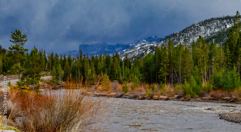 Mountain river with muddy water, melting snow in the mountains. Mountain landscape. Mountain river with muddy water, melting snow in the mountains. Mountain landscape.