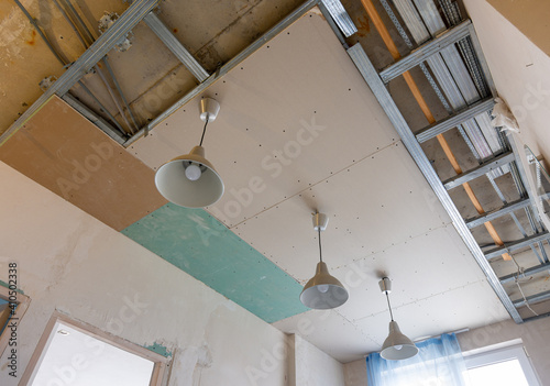 Unfinished two-level plasterboard ceiling in the interior of a room in a new building