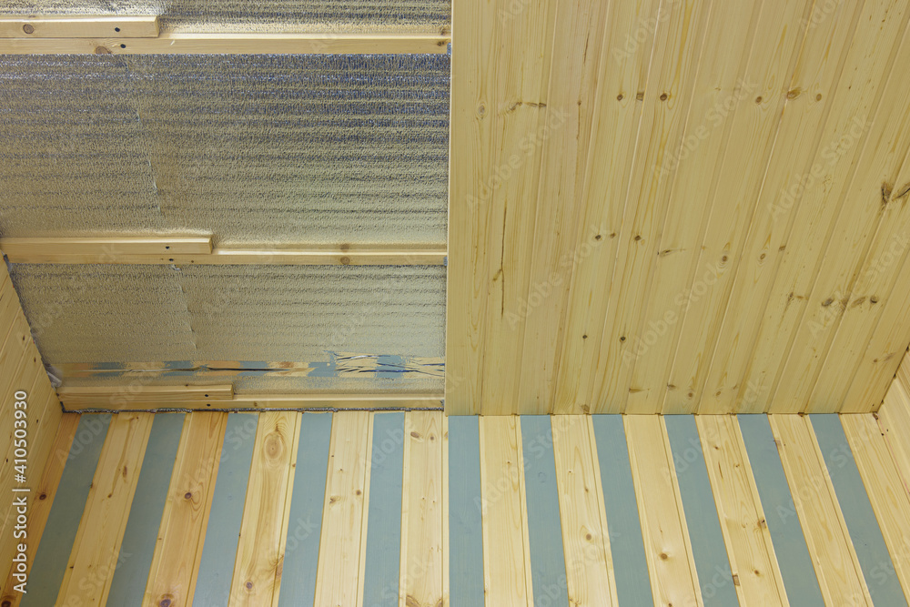 finishing with wooden clapboard ceiling in the room of a country house finishing with wooden clapboard ceiling in the room of a country house