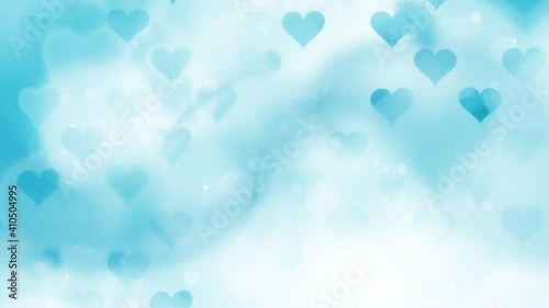 Abstract blue white colored hearts on blurry smooth bokeh copy space background. Concept modern Valentine's Day slow motion animation.
