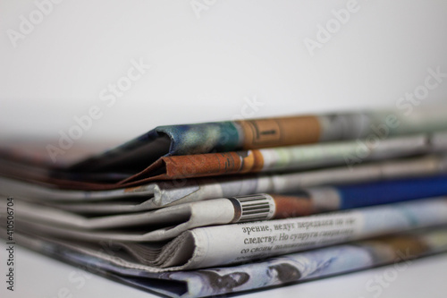 Stack of newspapers and glasses in black and white.