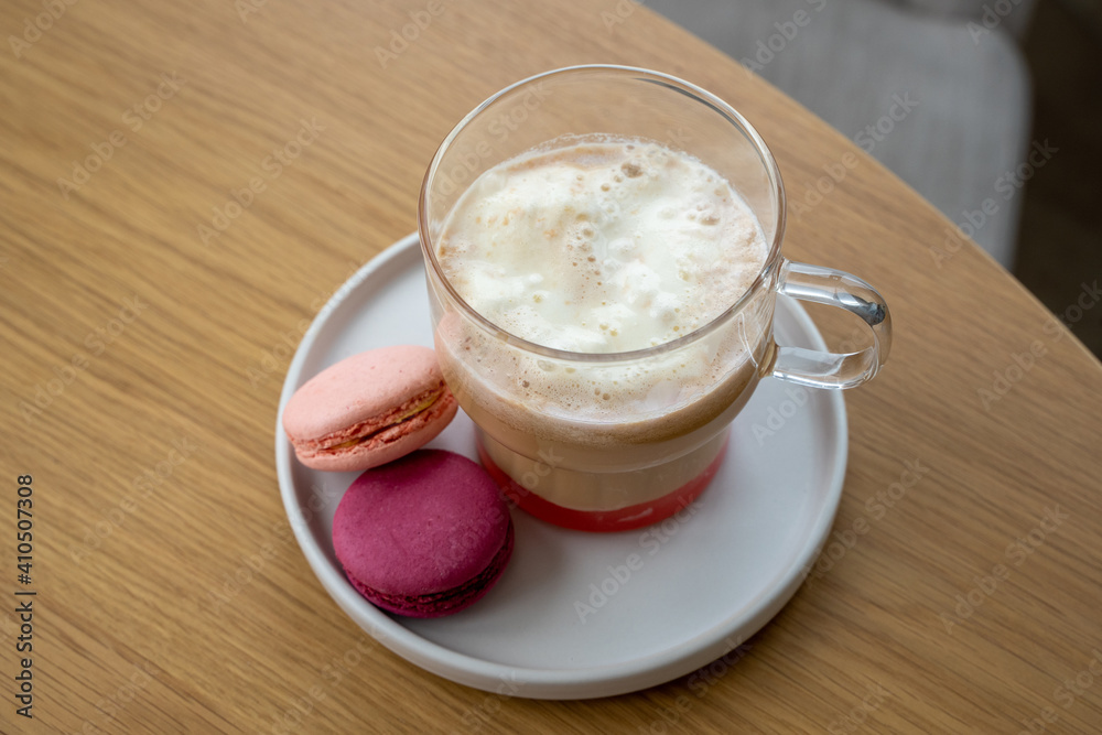 A cup of coffee with iice cream, syrup and macaroons on the table. High quality photo