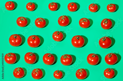 Fresh tomatoes on a green background