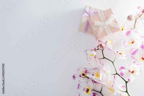 Gift boxes with orchid on white background. Presents for Valentine's day