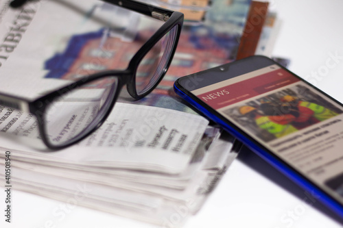 Stack of newspapers and glasses in black and white
