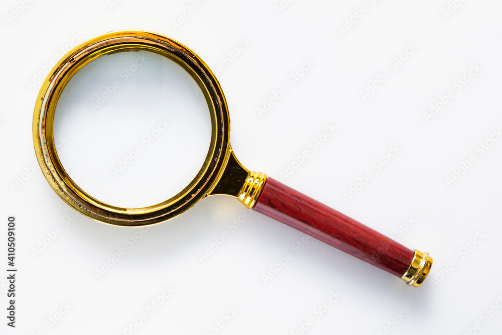 Golden magnifying glass with maroon handle Golden magnifying glass with maroon handle