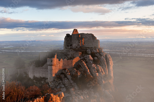 French winter landscapes. Stunning panoramic view of castle ruins Crussol. Foggy mountain landscape at sunrise.