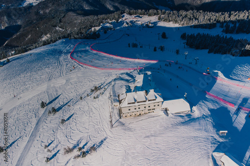 Aerial panorama of ski slope of Krvavec in Slovenia, visible also a ski race course between the red fence. photo