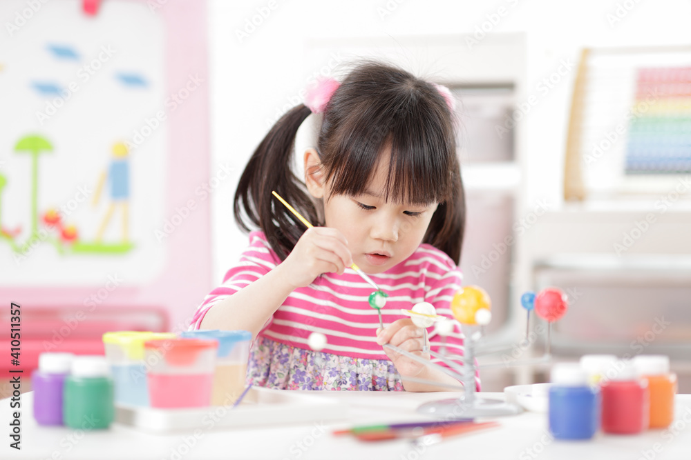 young girl making craft for homeschooling