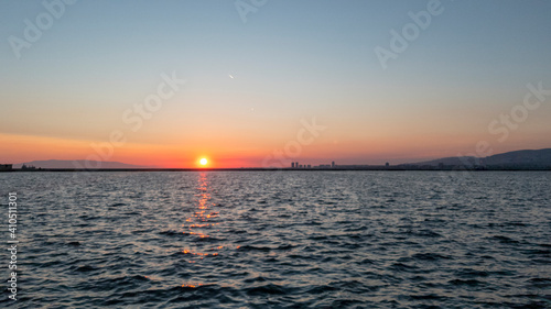 Colorful sunset with sea and sun on the horizon. Izmir, Turkey. photo