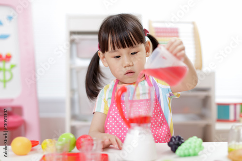 young girl pretend play food preparing at home