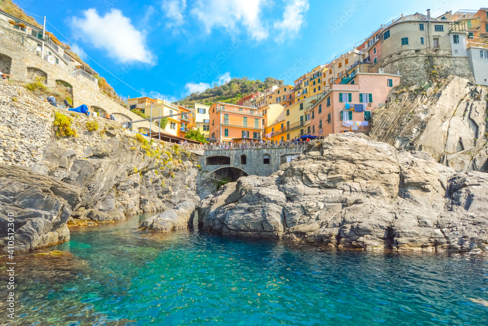 The colorful Cinque Terre village of Manarola, Italy, perched on a hillside of granite rock overlooking the Ligurian sea.
