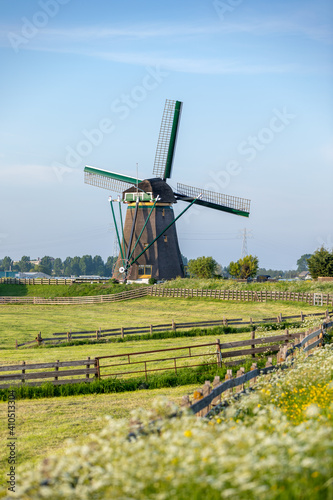 The historic Lisserpoel windmill build in 1676. Along the river the Ringvaart. On the Rooversbroekdijk in the Hellegatspolder in the Netherlands. photo
