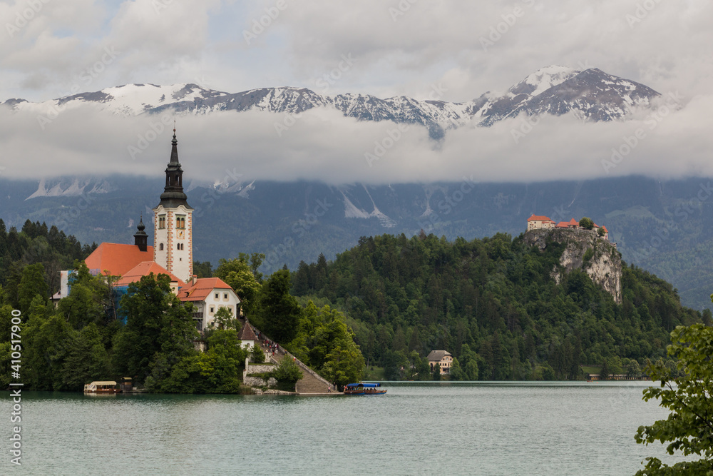 Karawanks mountain range behind Bled lake with the Pilgrimage Church of the Assumption of Maria and Bled Castle, Slovenia