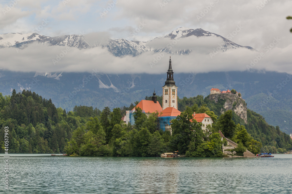 Karawanks mountain range behind Bled lake with the Pilgrimage Church of the Assumption of Maria and Bled Castle, Slovenia