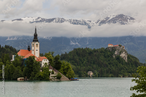 Karawanks mountain range behind Bled lake with the Pilgrimage Church of the Assumption of Maria and Bled Castle, Slovenia © Matyas Rehak