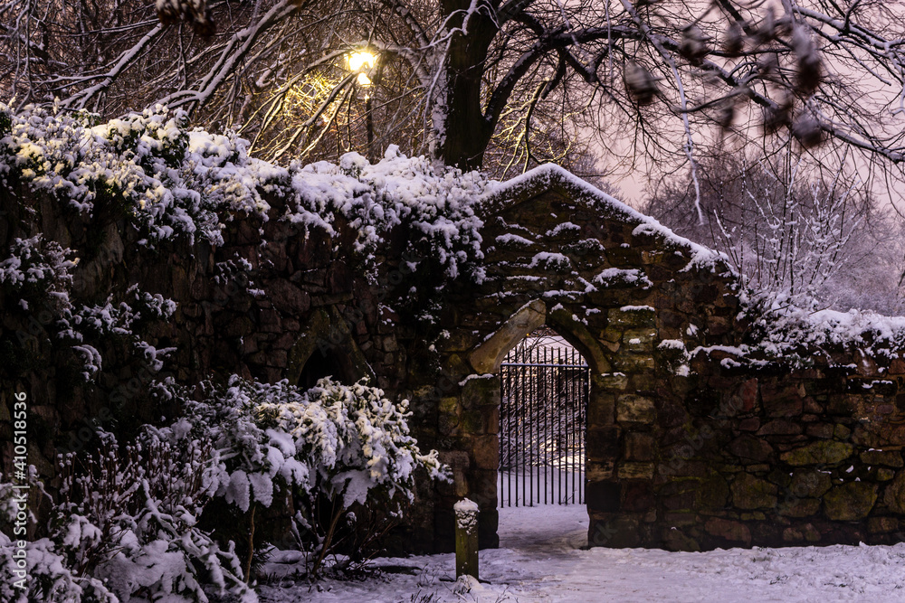 Naklejka premium Gate in abbey ruins in winter