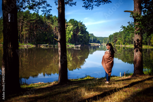 Girl posing against the backdrop of a lake or river. walk in nature