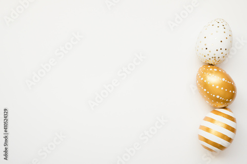 Easter golden decorated eggs isolated on white background. Minimal easter concept. Happy Easter card with copy space for text. Top view, flatlay
