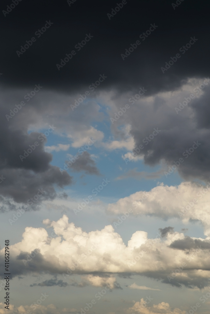 Blue sky behind dark storm clouds background texture, thunderstorm