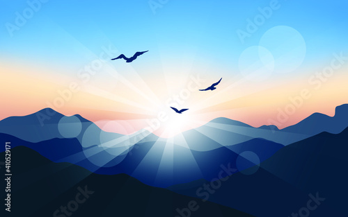 Birds flying over the mountains. Mountain sunrise