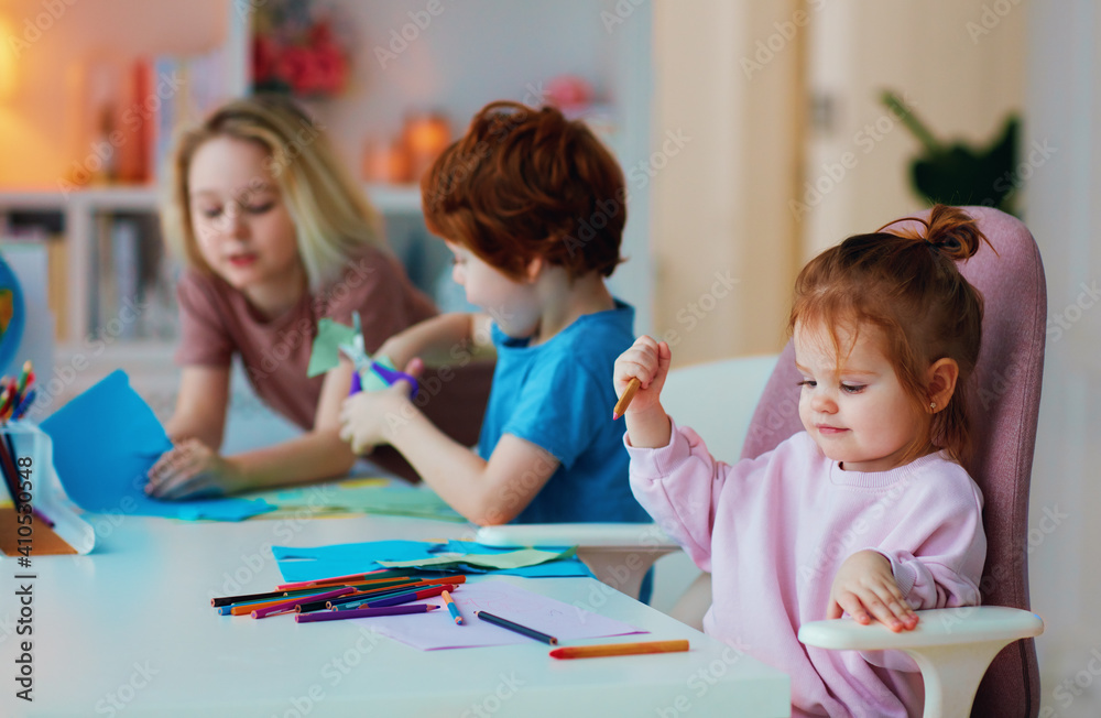 cheerful kids, siblings having fun, drawing with color pencils and cutting with scissors, home activities cheerful kids, siblings having fun, drawing with color pencils and cutting with scissors, home activities
