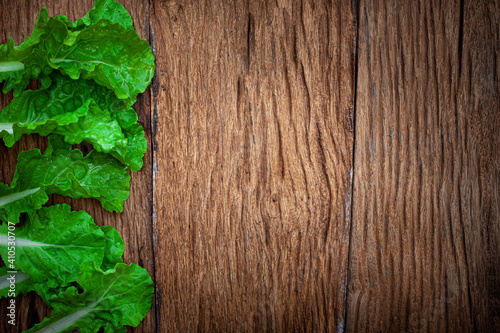 Bio food. green Lettuce leaves pattern on old wooden background  copy space 