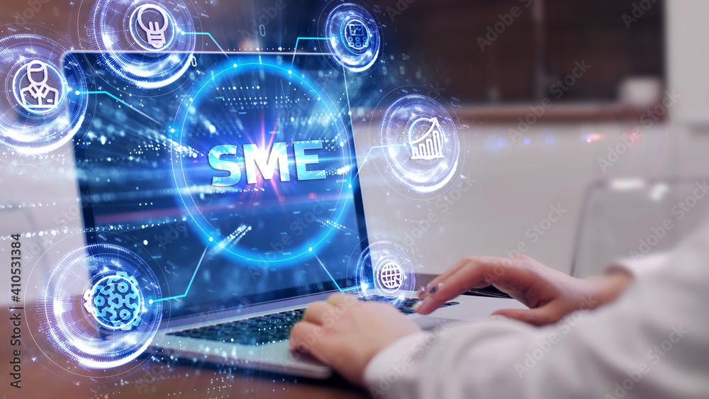 The concept of business, technology, the Internet and the network. A young entrepreneur working on a virtual screen of the future and sees the inscription: SME The concept of business, technology, the Internet and the network. A young entrepreneur working on a virtual screen of the future and sees the inscription: SME