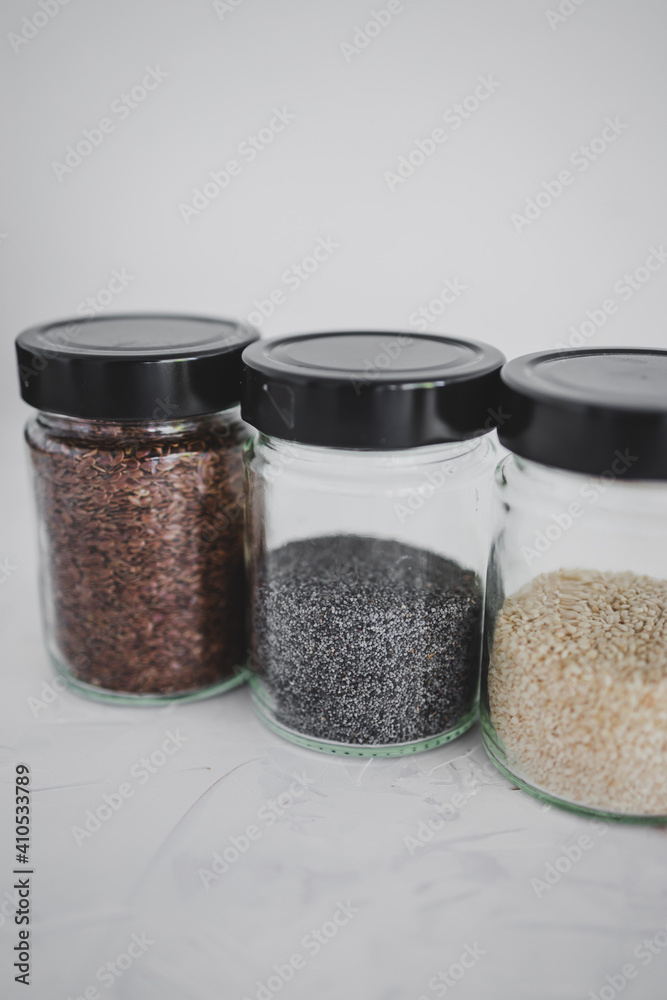 seed jars with sesame poppy pupmkin chia and flax seeds as important nutrient sources for nutrition shot on white background seed jars with sesame poppy pupmkin chia and flax seeds as important nutrient sources for nutrition shot on white background