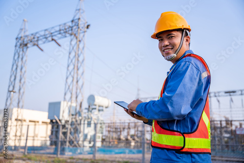 Happy asian electric engineer check the transmission station.