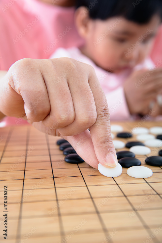 Young mothers teach their children to play go Young mothers teach their children to play go